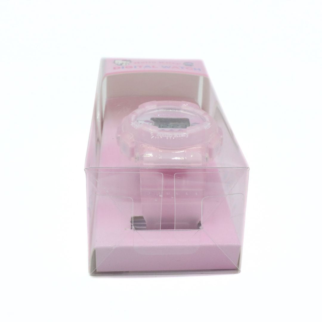Pink digital watch in a clear box on a white background