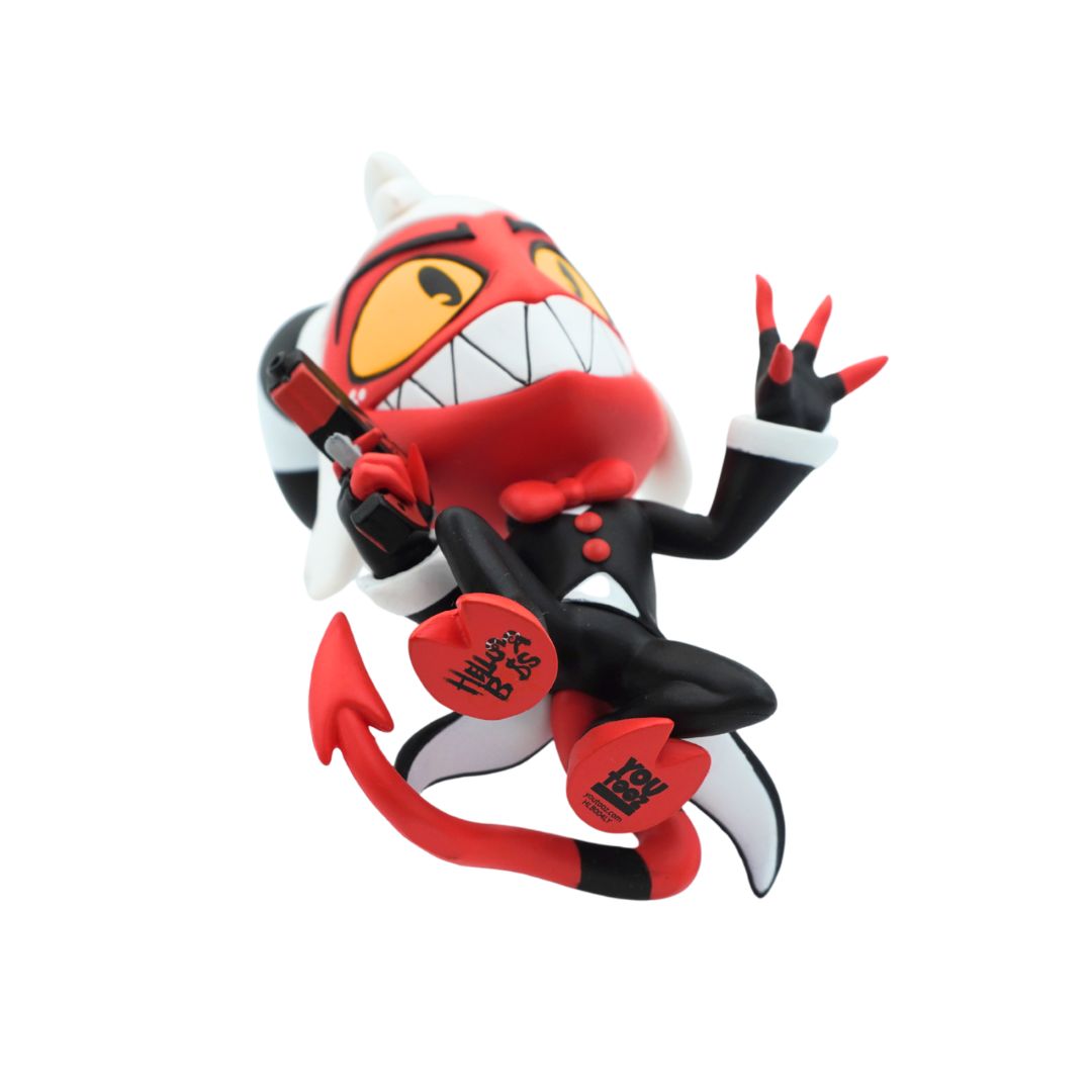 A stylized Helluva Boss character figurine posed mid-action, featuring a red and black outfit, white horns, yellow eyes, and red claws, photographed on a plain white background.