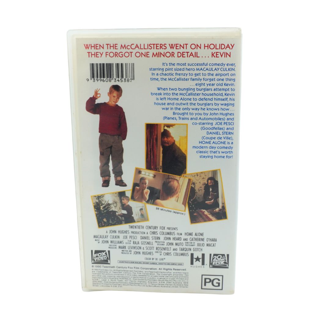 Back cover of a VHS or DVD case for the movie 'Home Alone' featuring cast photos, synopsis text, and a PG rating logo on a white background.