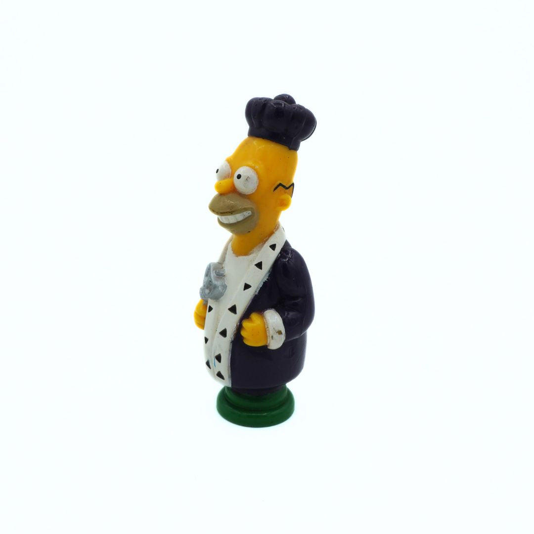 Simpsons figurine of a character in a chef's outfit on a white background