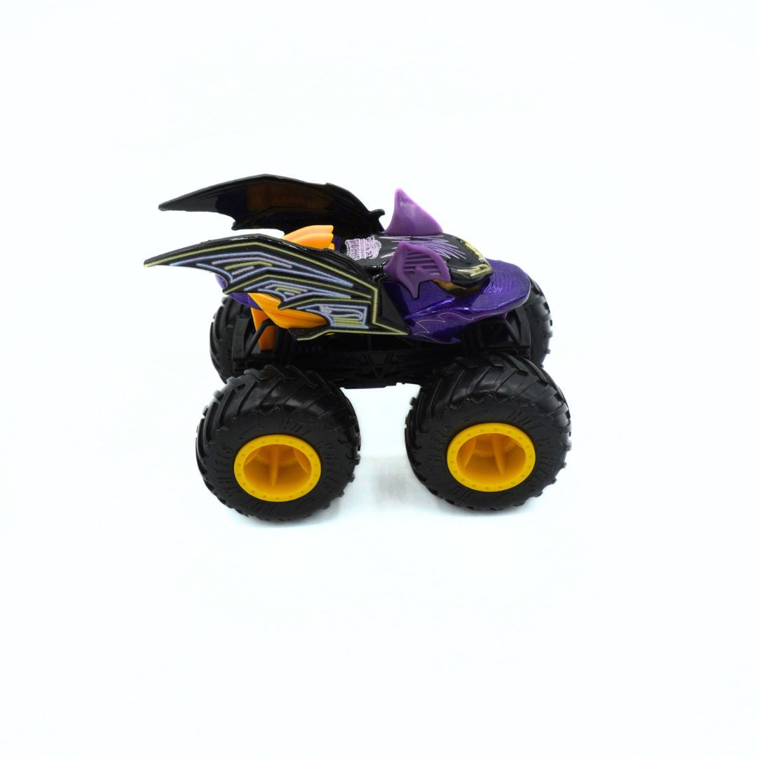 A small toy monster truck with black tires, purple body panels, yellow wheel centers, and bat-wing side details, photographed on a plain white background.