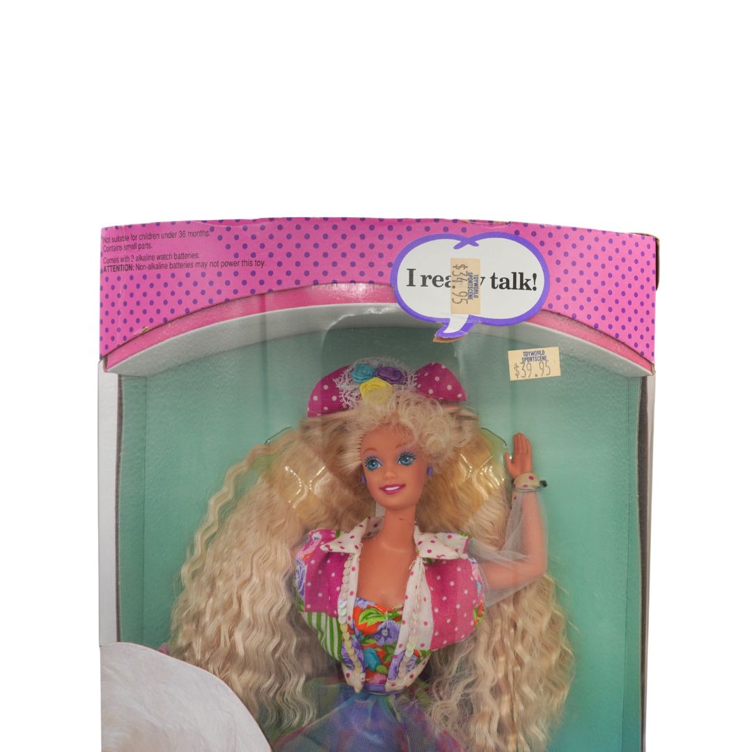 Barbie doll in packaging with 'I really talk!' label
