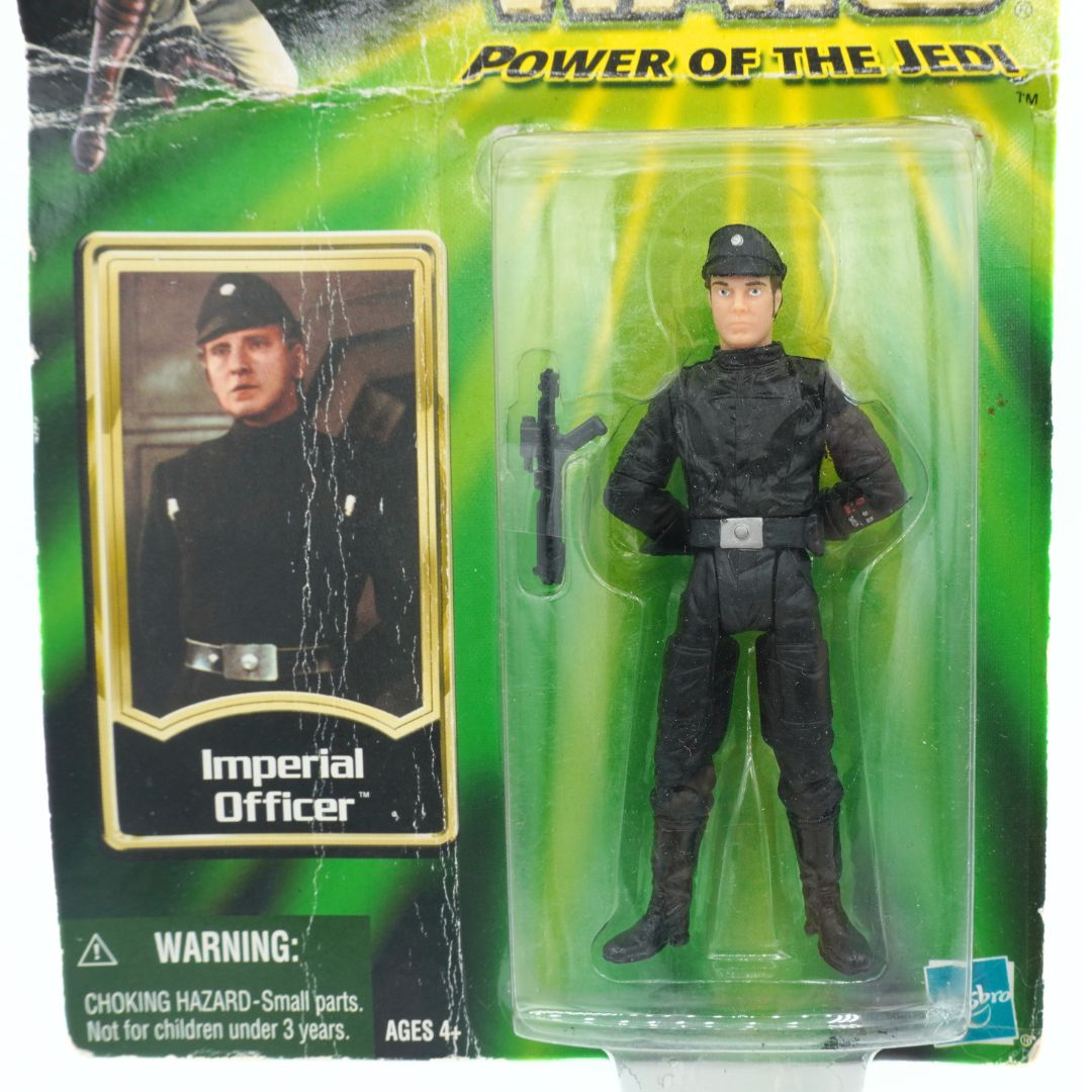 Toy figure of an Imperial Officer in packaging with a card featuring the character, on a green background.