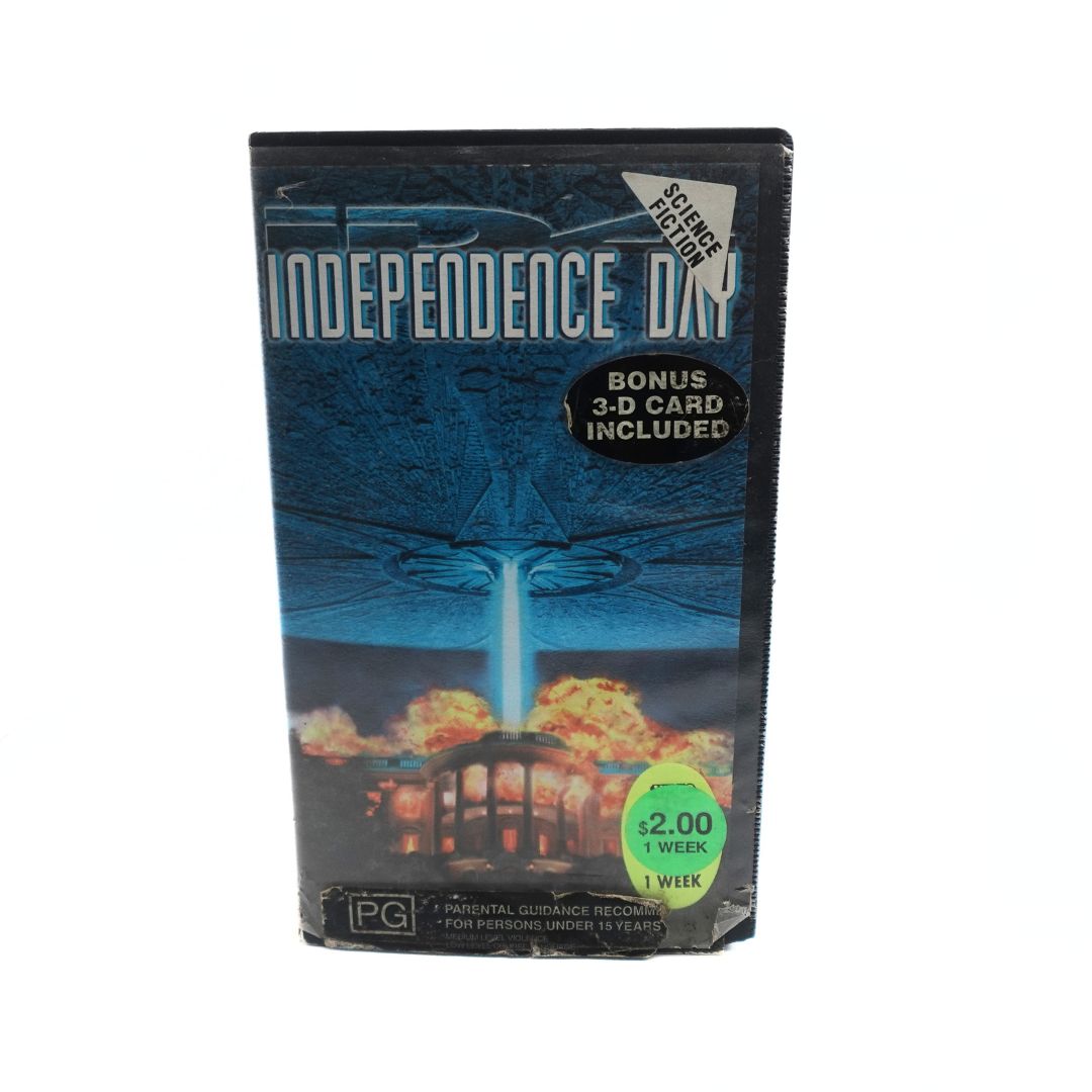 Image of the front cover of the VHS tape Independence Day showing damage to the case and added stickers