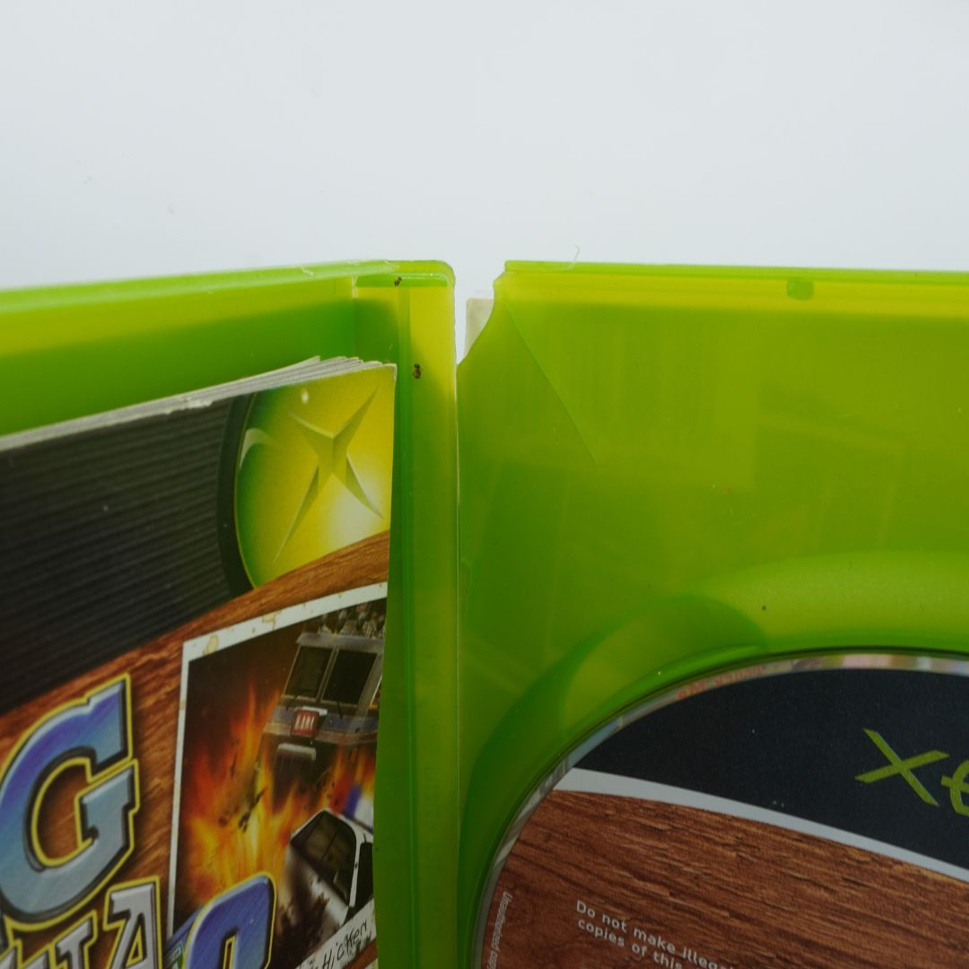 Close-up of a green plastic item with a game case inside, on a white background