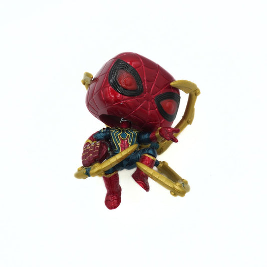 Toy figure of a superhero in red and blue costume with gold accents on a white background