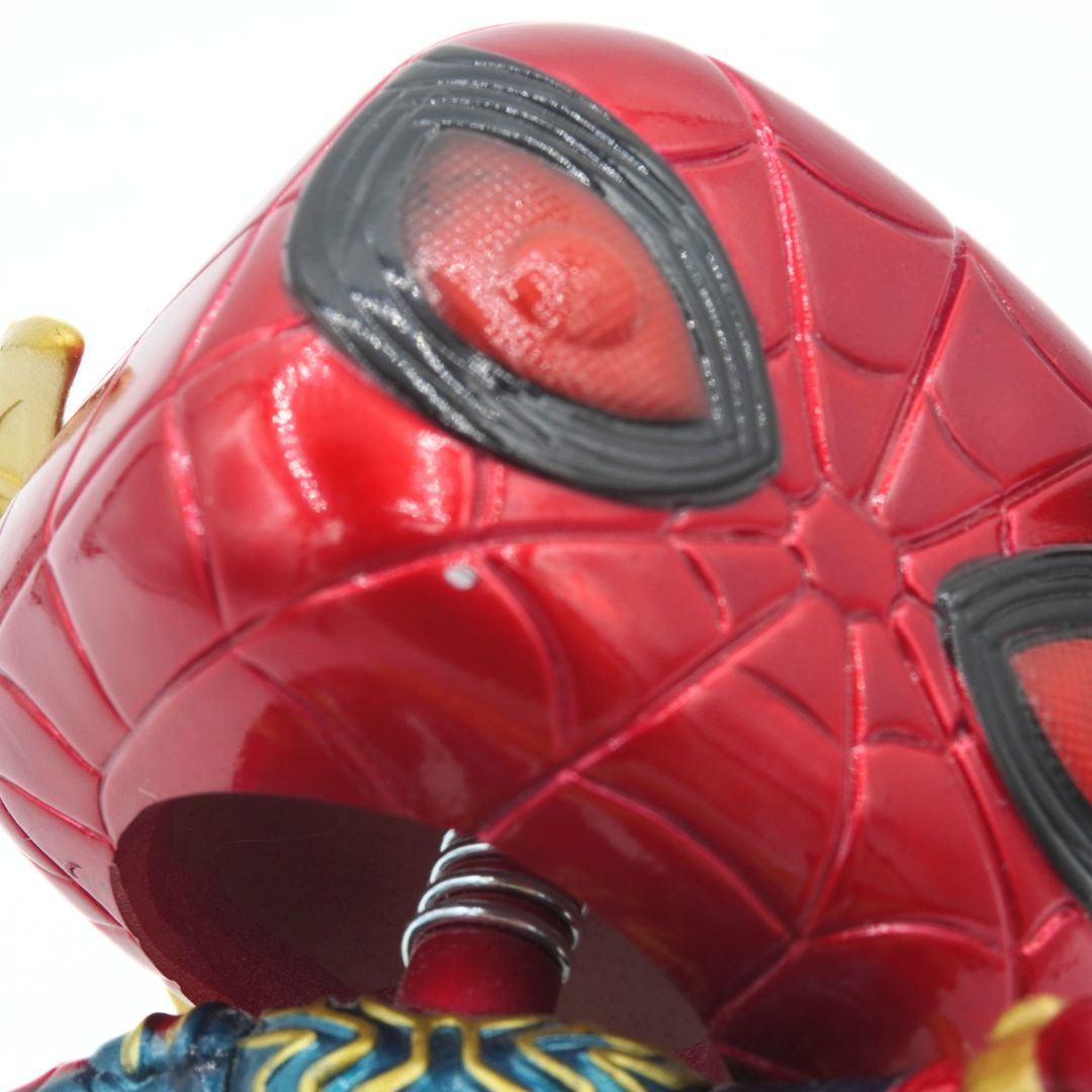 Close-up of a red superhero mask with black accents on a white background