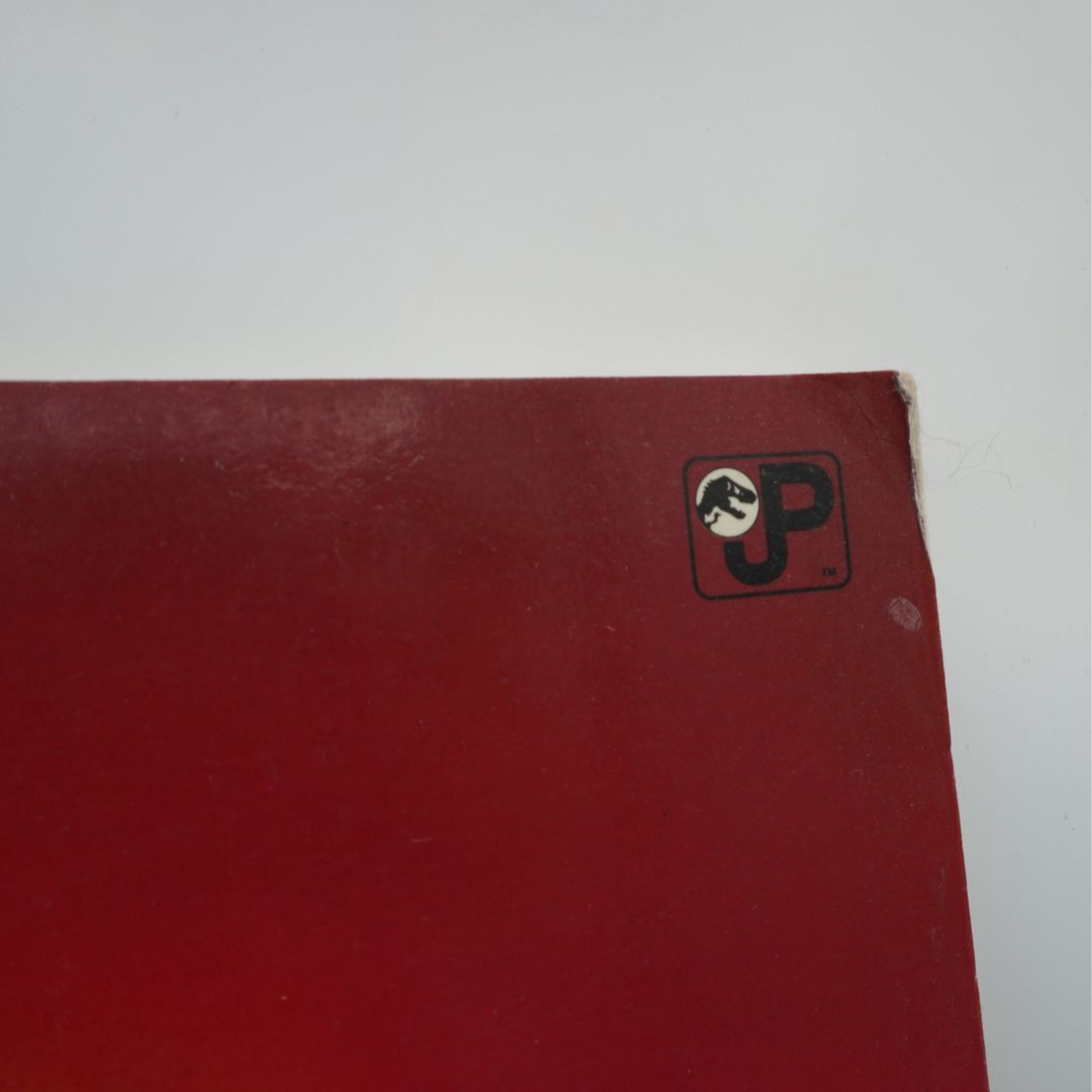 Corner of a red book cover showing some minor corner damage
