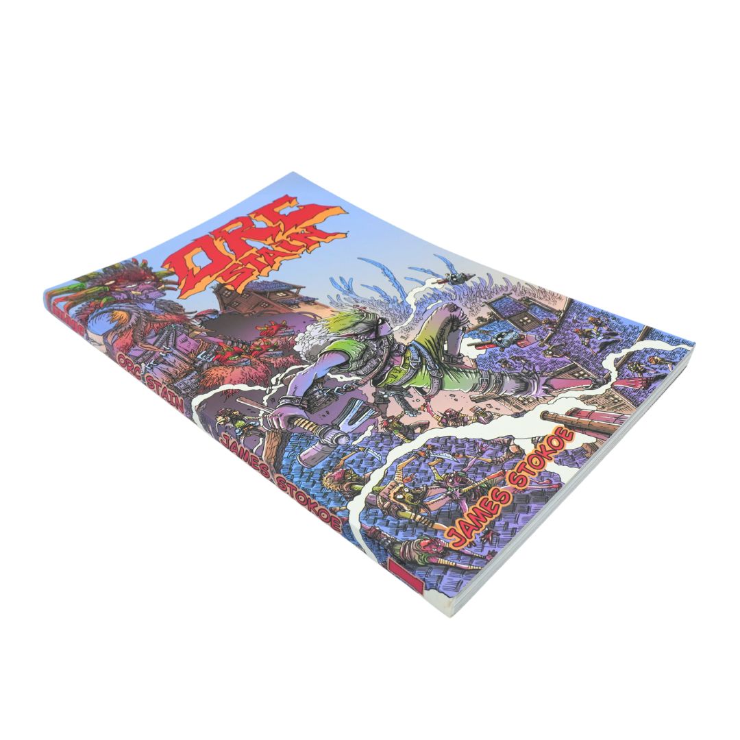 A hardcover book or magazine titled 'Orc Stain' with a highly detailed, colorful psychedelic illustration on the cover, shown at an angle on a plain white background.