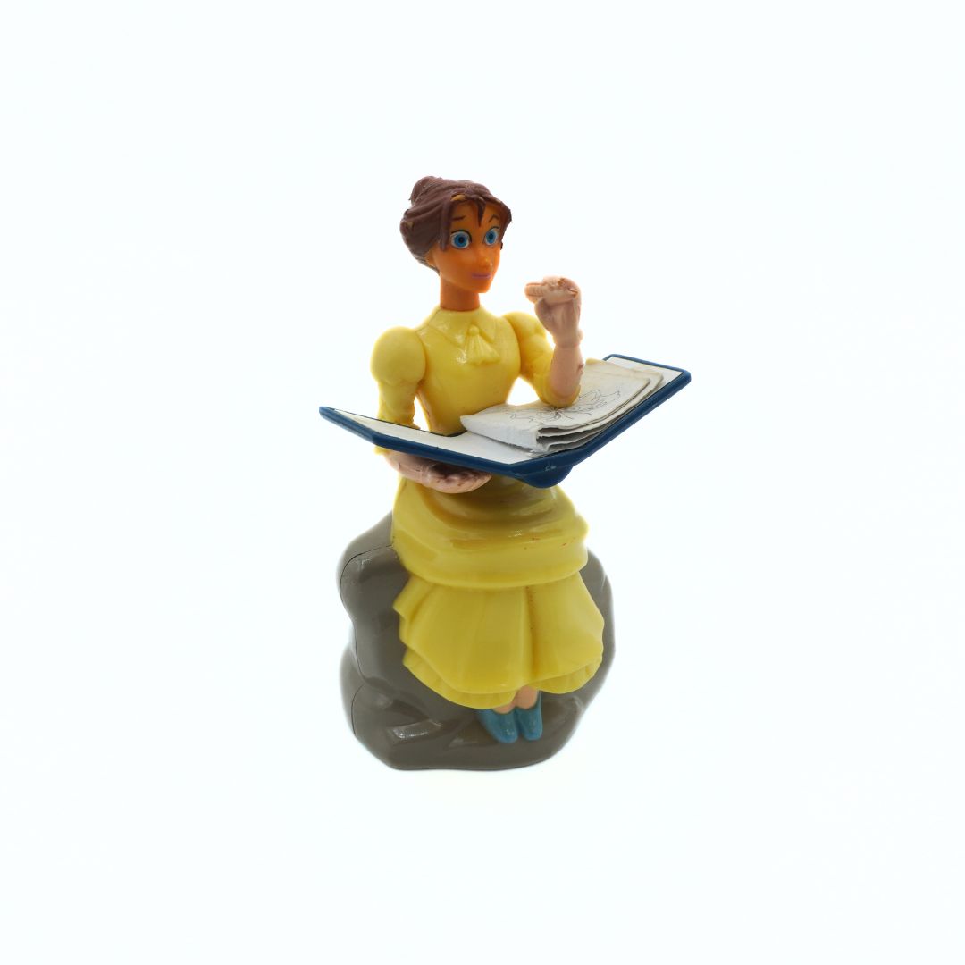 Figurine of a woman in a yellow dress holding a tablet on a white background