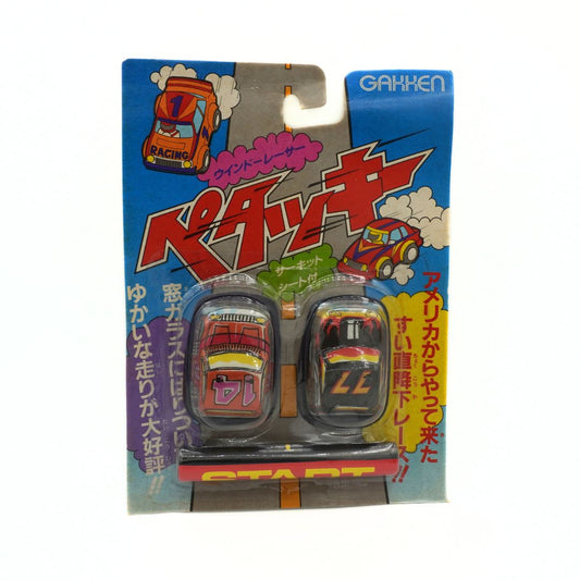 Packaged toy cars with colorful box featuring Japanese text and graphics.