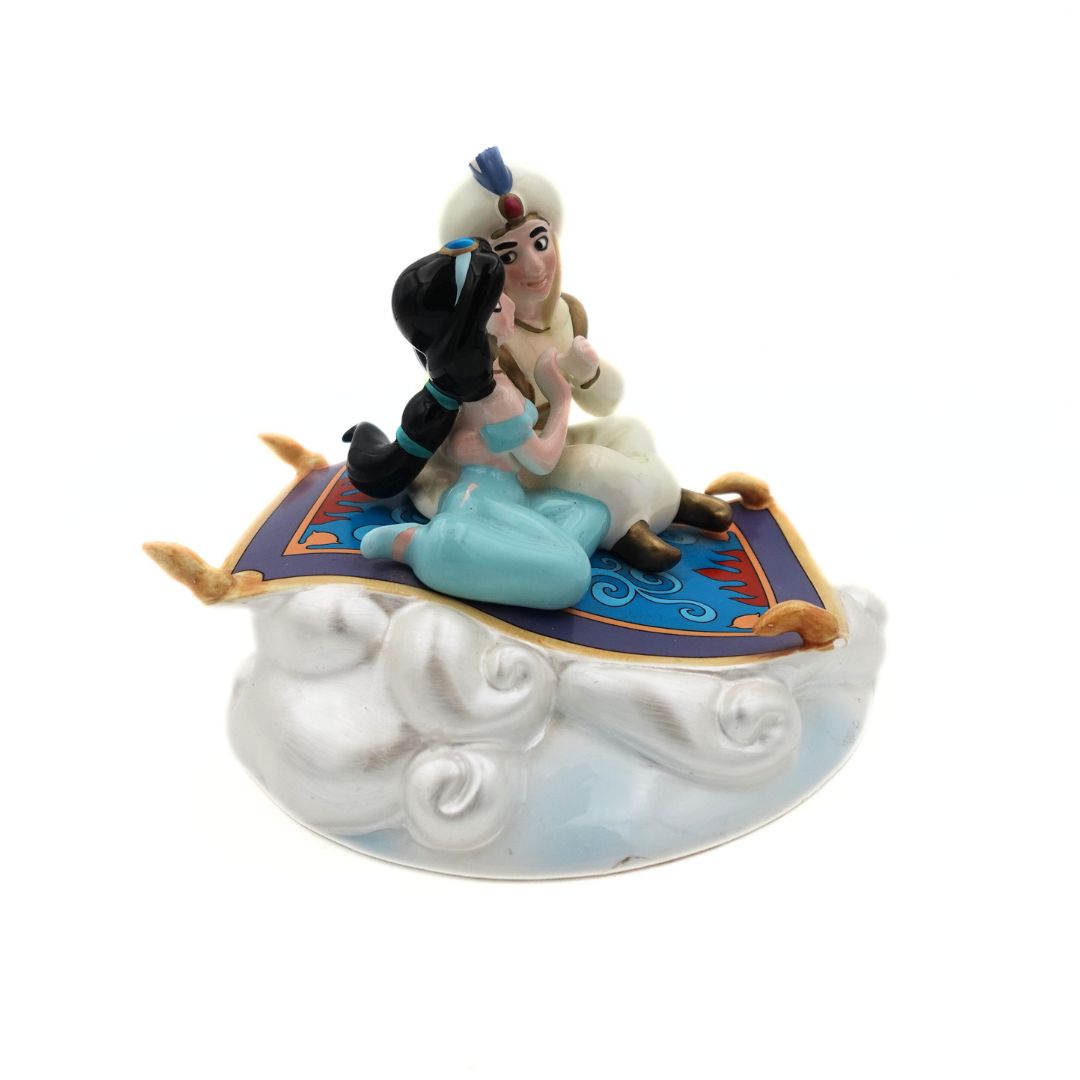 A hand painted 1993 Jasmine and Aladdin Magic Carpet music box atop silver clouds