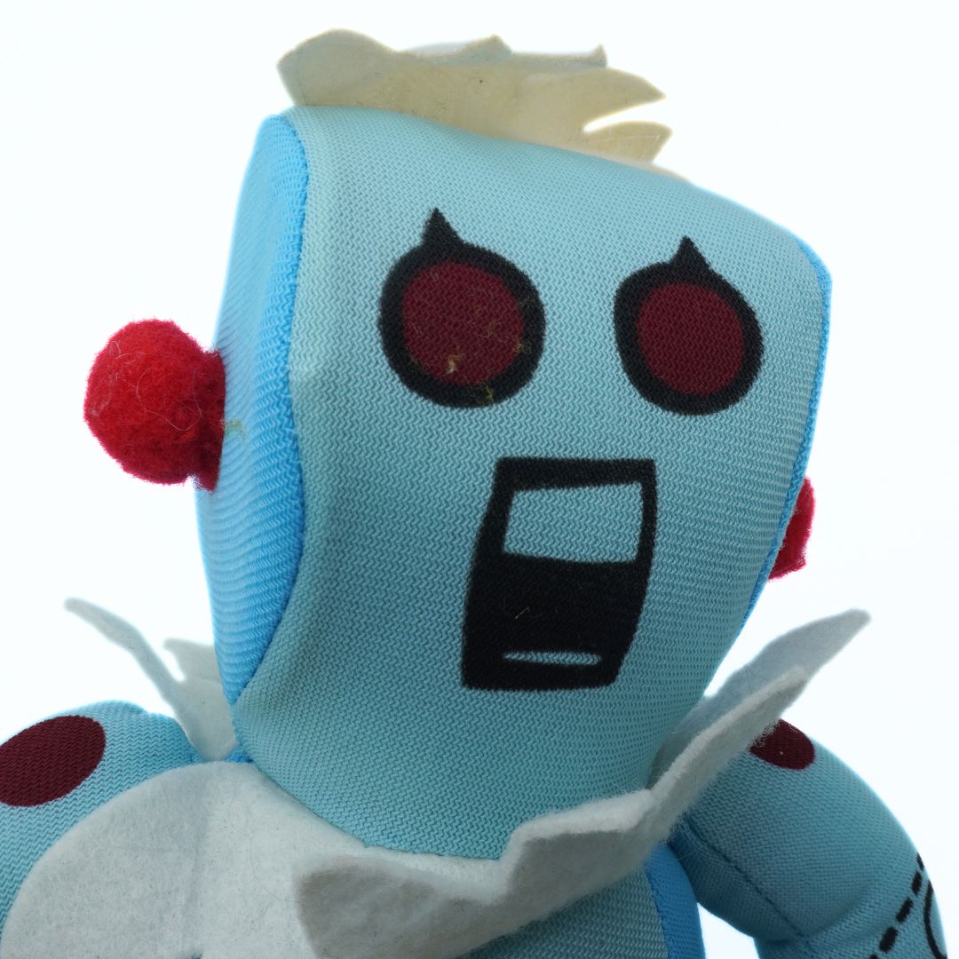 Plush toy with a blue face, red eyes, and white hair on a white background
