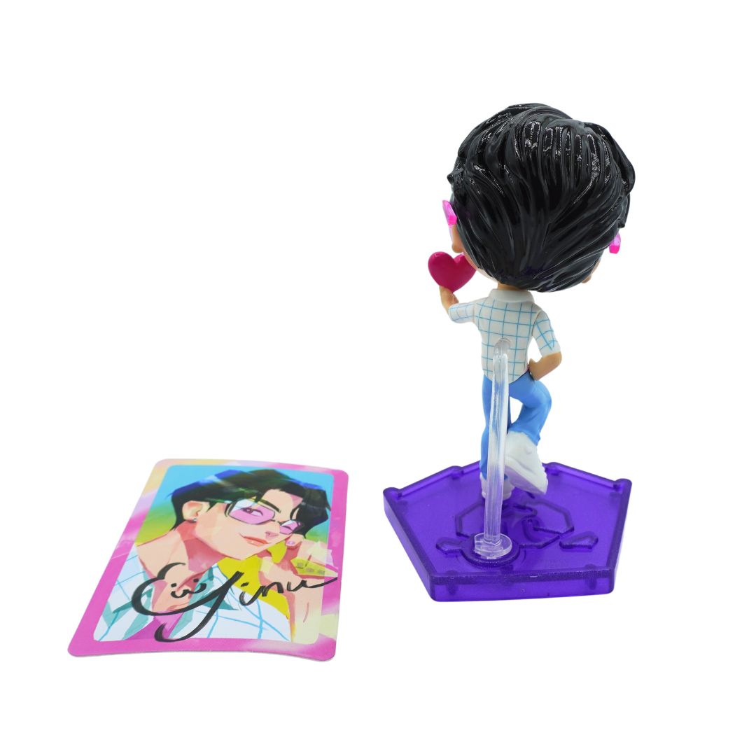 Back of a figure of Jinu, with black hair and blue pants on a purple stand. 