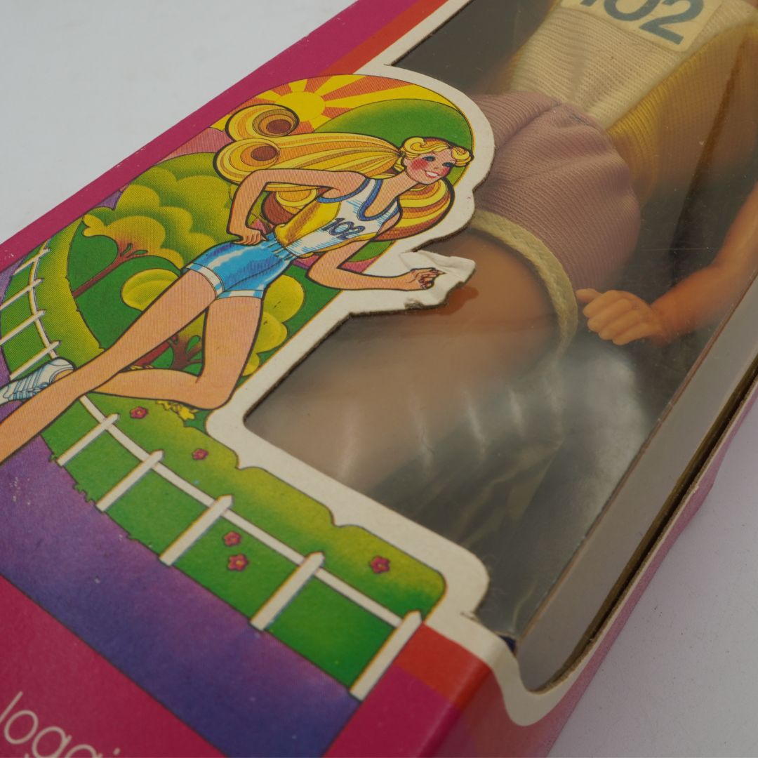 Vintage toy packaging with a character on a slide, featuring bright colors.