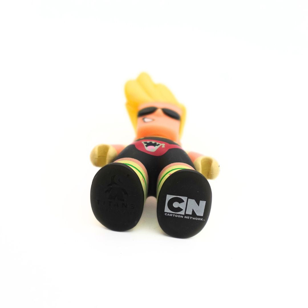 A photo of the underside of the small Johnny Bravo figure wearing a button up shirt, overalls and a bumbag