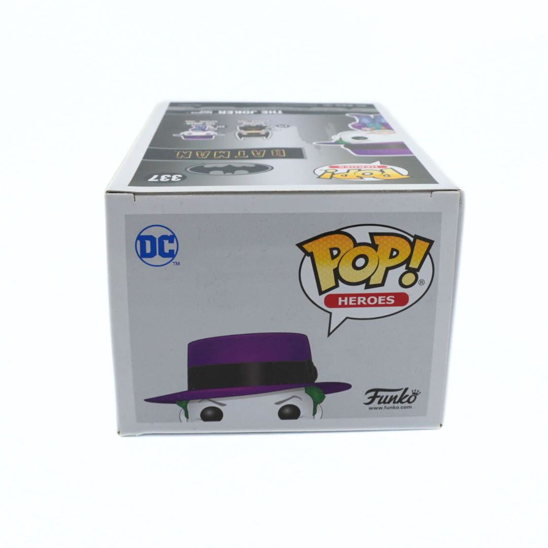 Funko Pop! Heroes Batman figure box, number 337, featuring the DC logo and a purple fedora illustration on a white background.