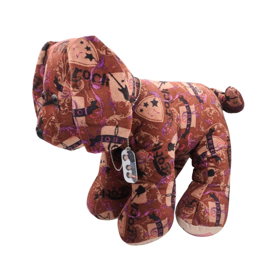 Plush dog toy with cowboy pattern on a white background