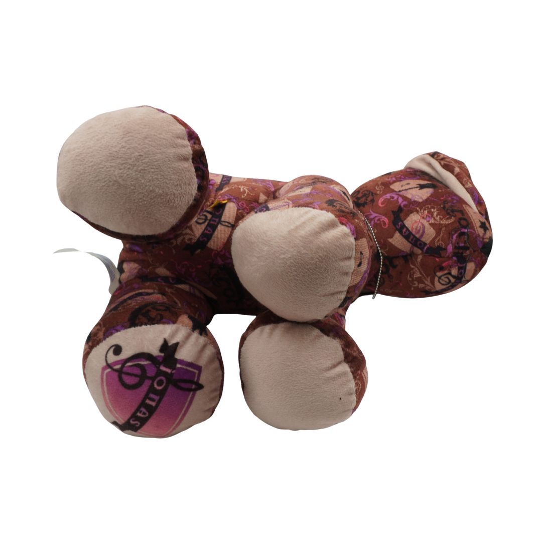 Plush toy dog with a brown design and Jonas Brothers inspired print