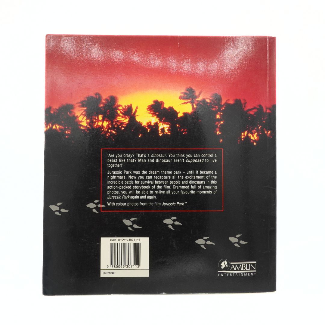 Back cover of a book with a sunset over trees design and text.