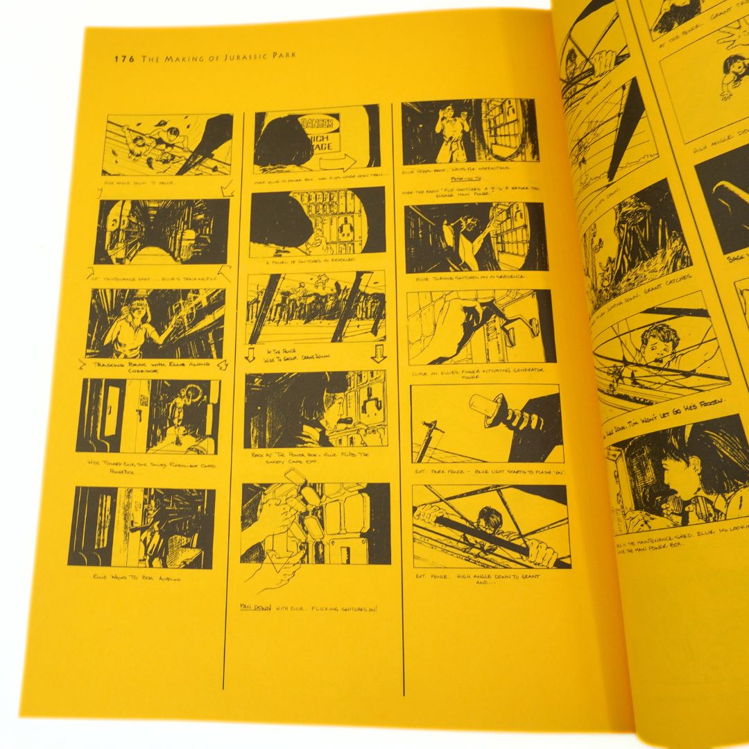 Open book with black illustrations on yellow pages