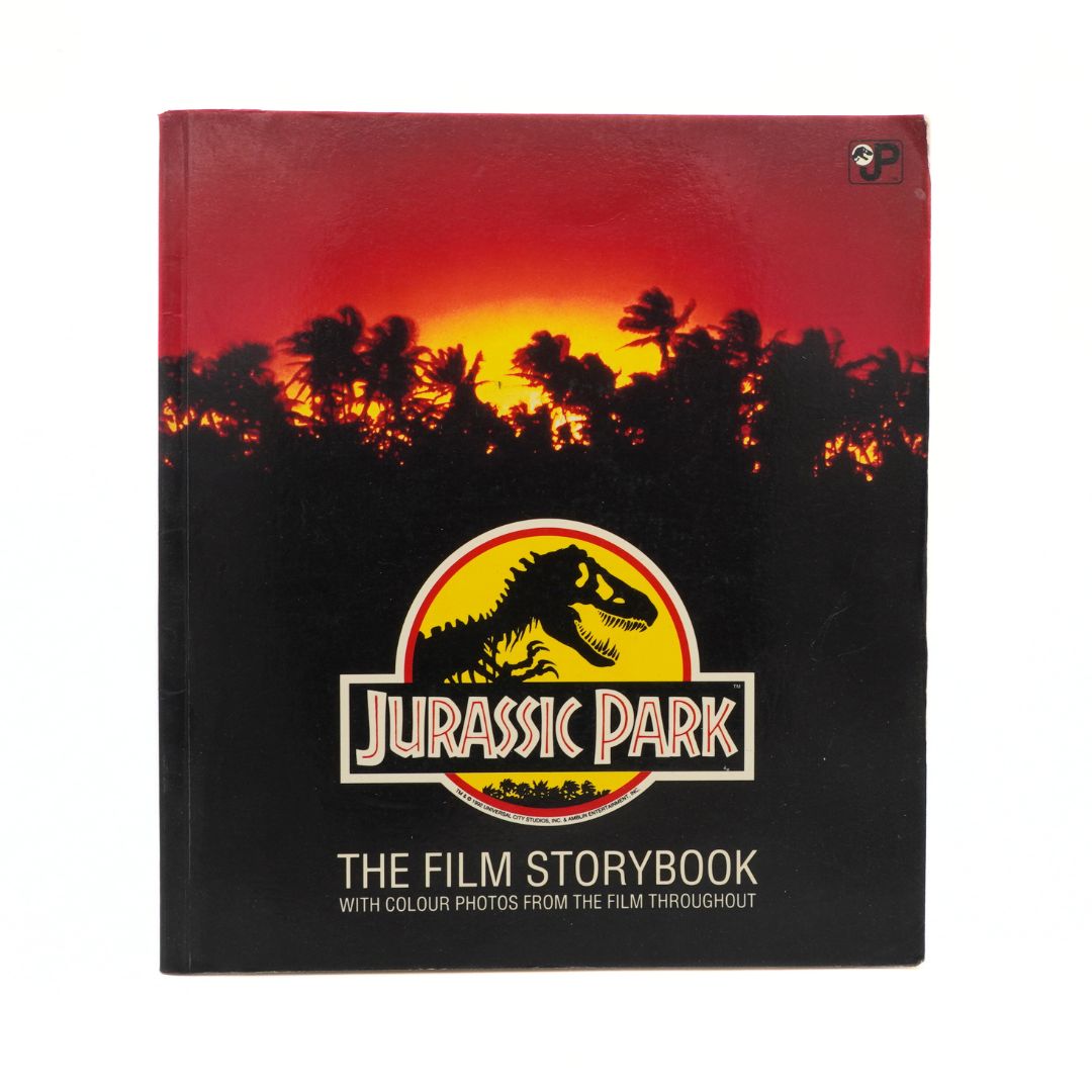 Jurassic Park book cover with sunset and dinosaur silhouette