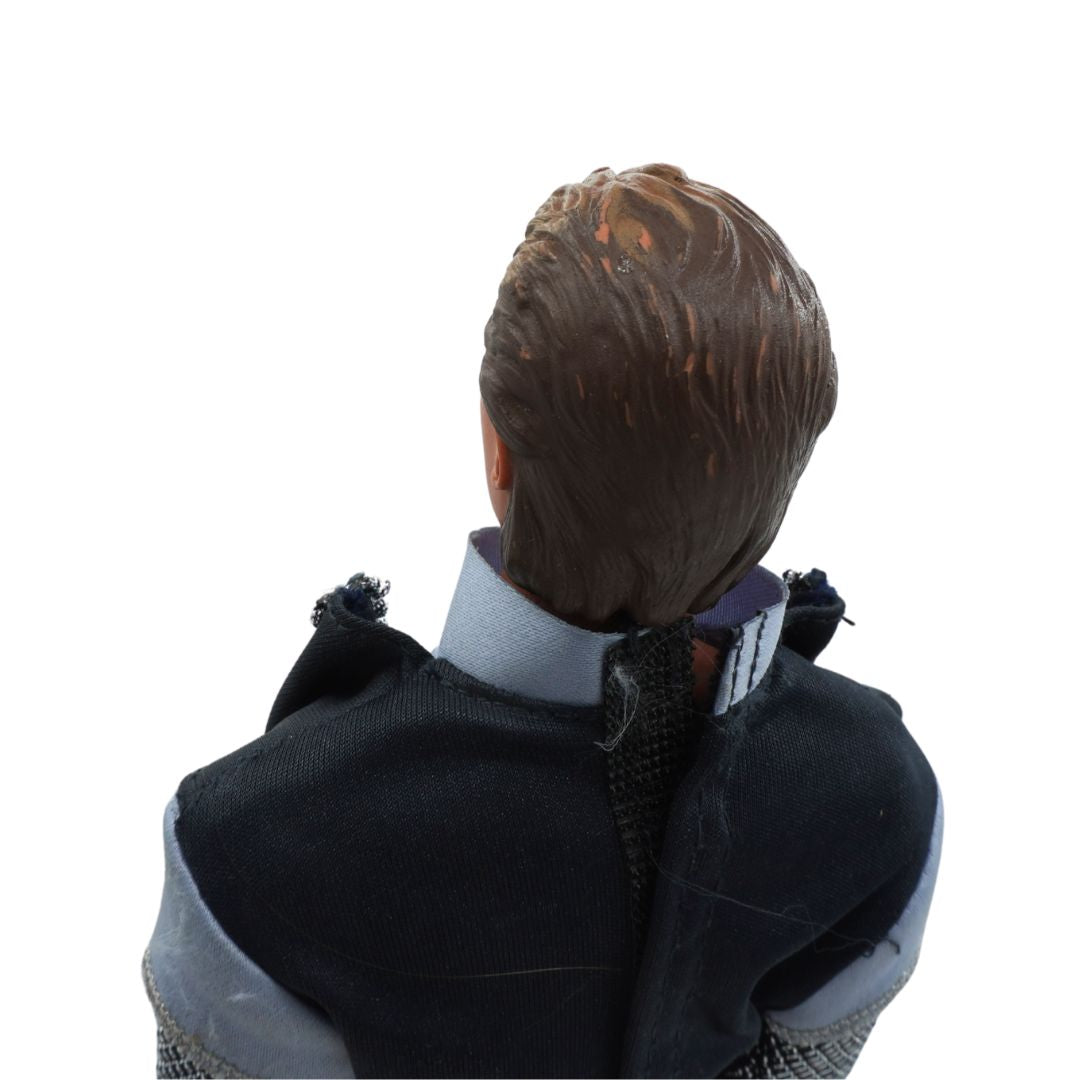 Back view of a person wearing a dark coat with a white shirt underneath on a white background