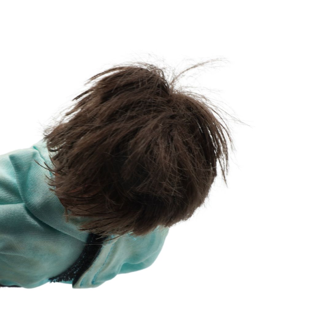 Close-up of a person wearing a light blue shirt with brown hair.