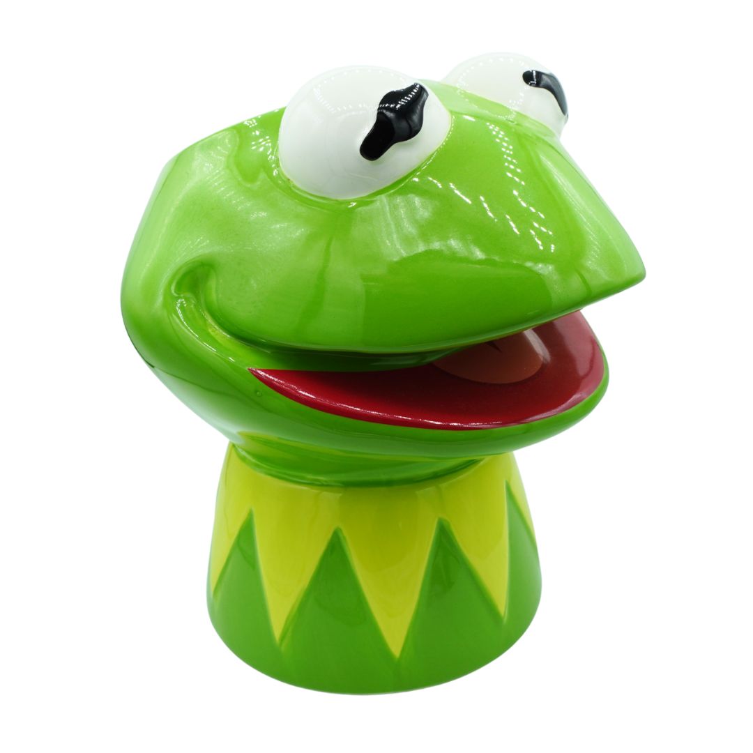 A glossy ceramic Kermit the Frog figurine, featuring bright green skin, large white eyes with black pupils, and an open red mouth, set against a plain white background.