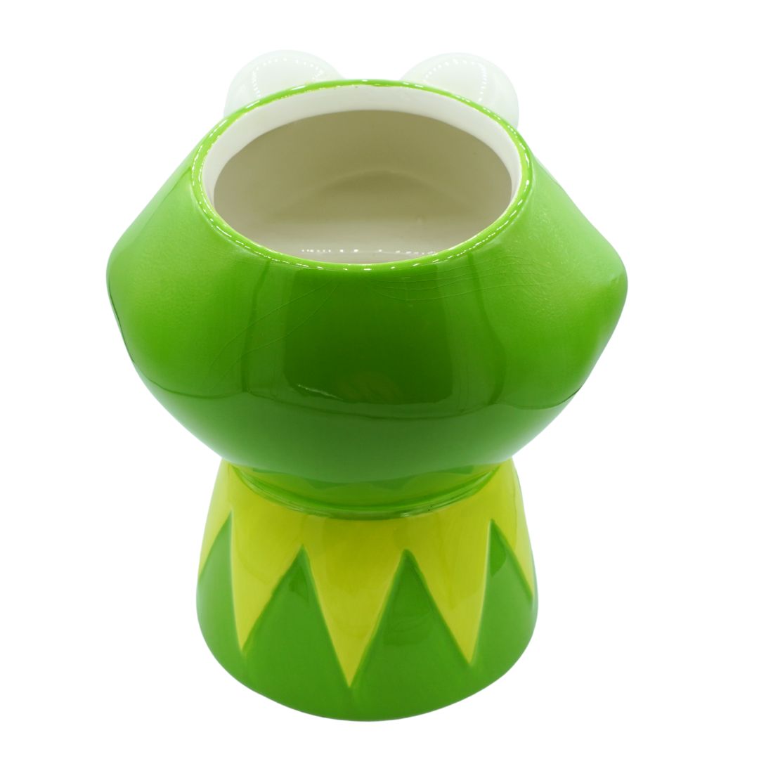 A green ceramic frog-shaped cup or planter with a wide opening at the top, shown on a plain white background.