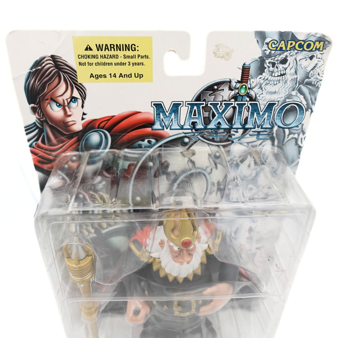 Top of the Capcom Maximo King Achille figure showing the cardback with a yellow warning sticker