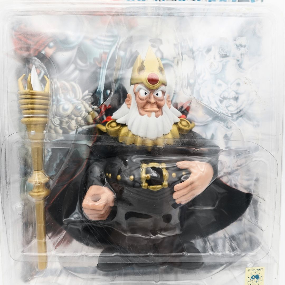 Closeup of the Maximo King Achille figure showing a black and gold outfit and a gold staff accessory