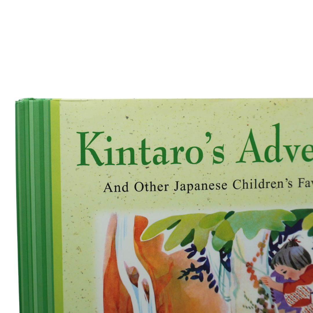 Close-up of a children's book titled "Kintaro's Adventure" with a light green cover, dark green title text, and colorful illustrated artwork near the bottom. The book spine is visible on the left with green bands.