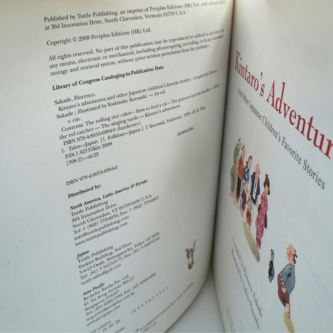 An open book showing the left page with publication details and text, and the right page featuring the title 'Kintaro's Adventure' and illustrated characters along the right margin.