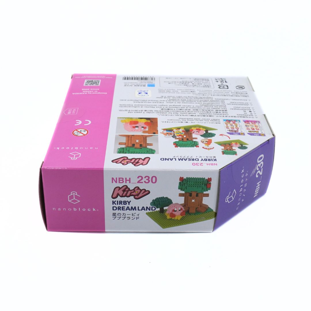 A boxed toy building block set photographed on a plain white background. The package is predominantly pink, white, and purple with printed product information, assembly diagrams, and small example builds featuring a treehouse and animal figures.
