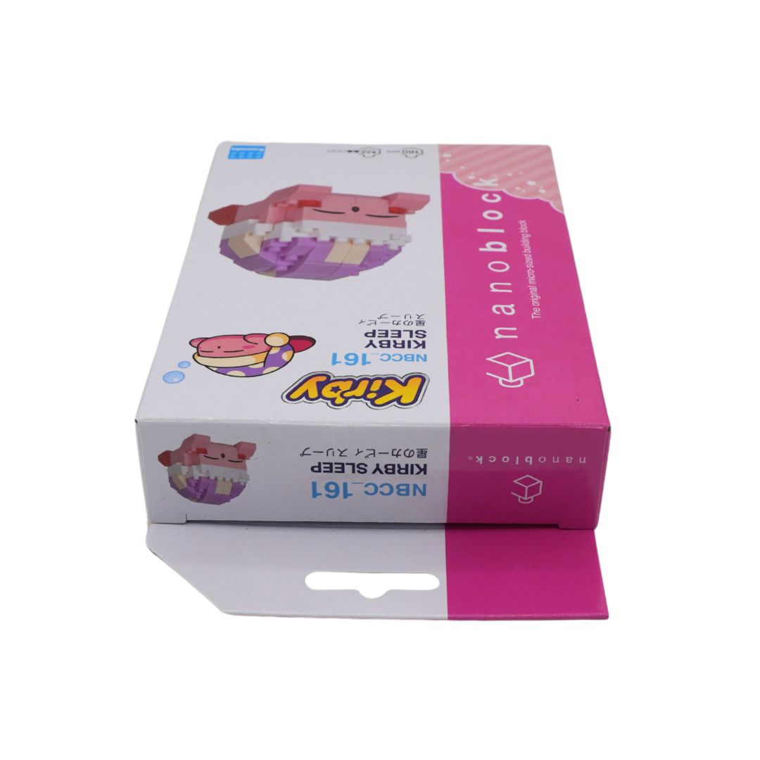 A boxed toy product labeled 'nanoblocks' and 'KIRBY SLEEP' with a pink-and-white package design and an illustration of a sleeping character, photographed on a plain white background.