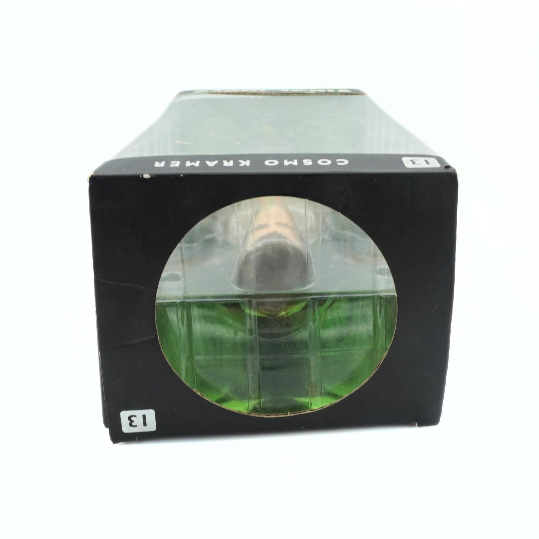 Top down image of a Kramer figurine in a black box