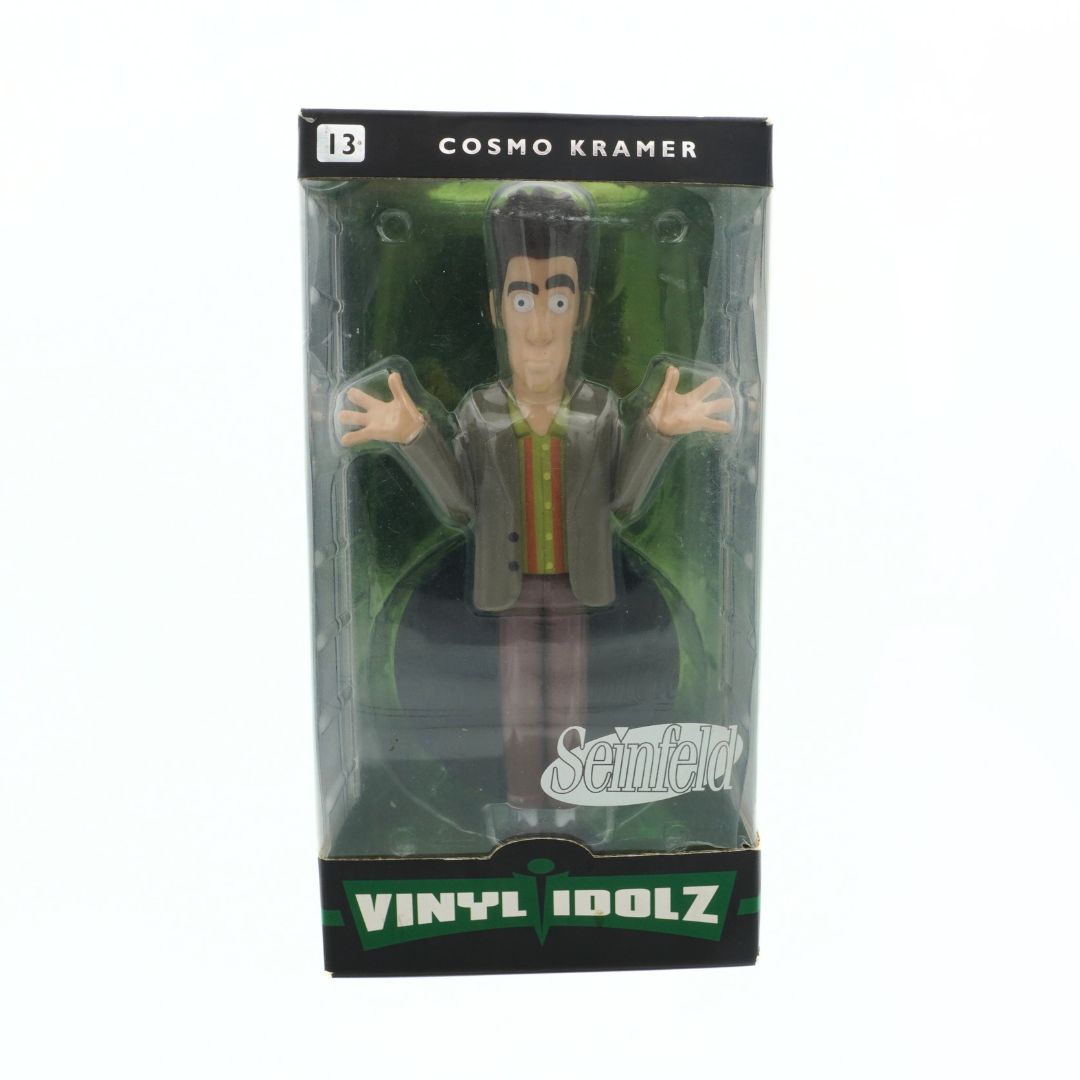 Packaged figurine of Cosmo Kramer from Seinfeld with 'Vinyl Idolz' branding.
