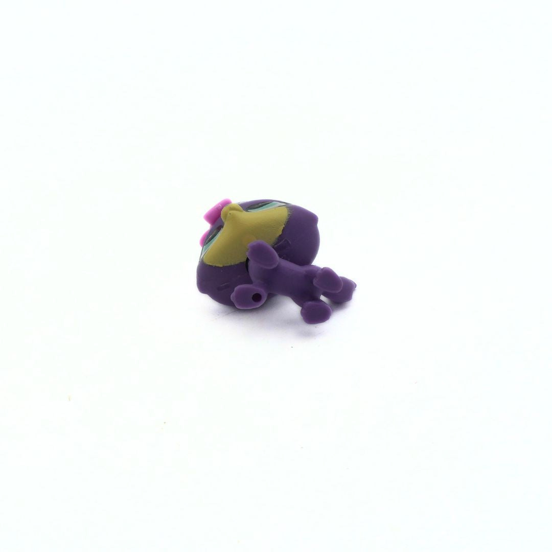 Small purple toy figure on a white background