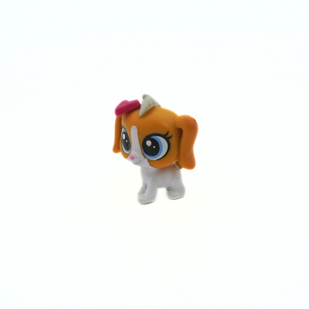Small toy figure with orange hair and a white body on a white background