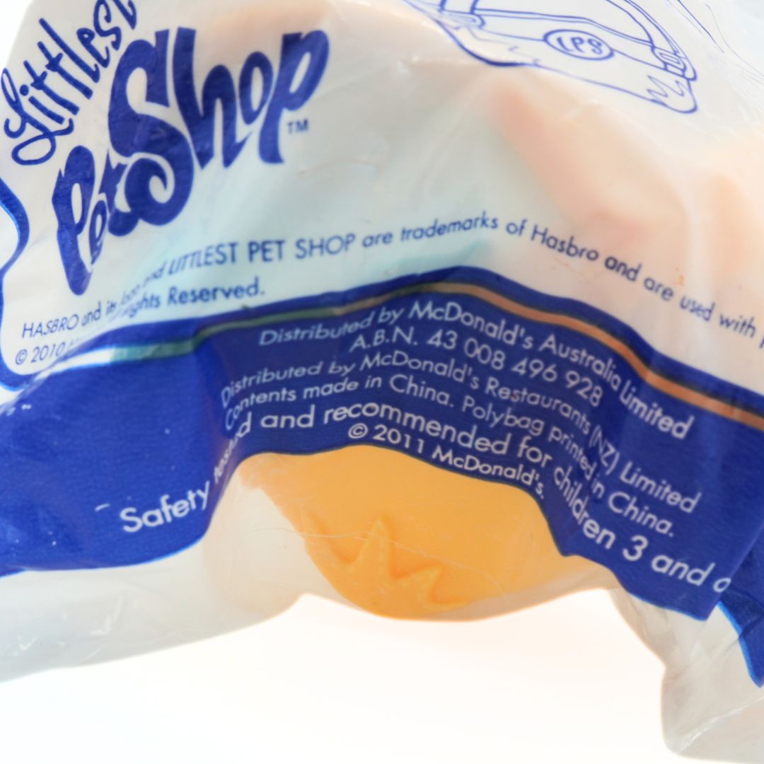 Close-up of a toy package with 'Littlest Pet Shop' branding and McDonald's logo.