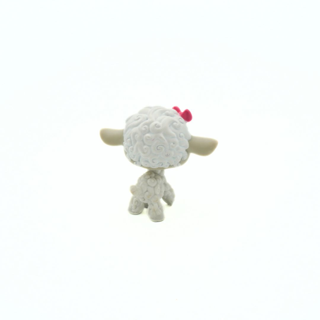 Small Littlest Pet Shop Lamb 879 figurine seen from behind with a pink bow