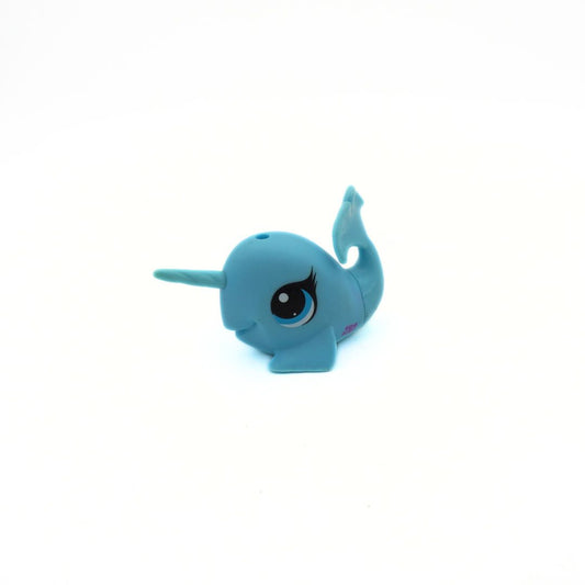 Small blue toy narwhal on a white background