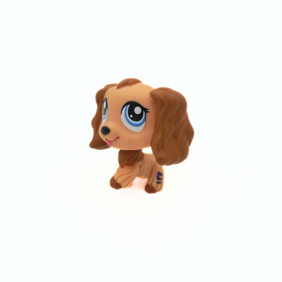 Small brown dog figurine with large blue eyes on a white background