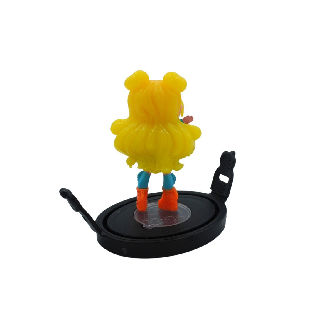 A small anime-style figurine shown from the back, featuring bright yellow hair, blue leggings, and orange boots, standing on a black circular base against a plain white background.