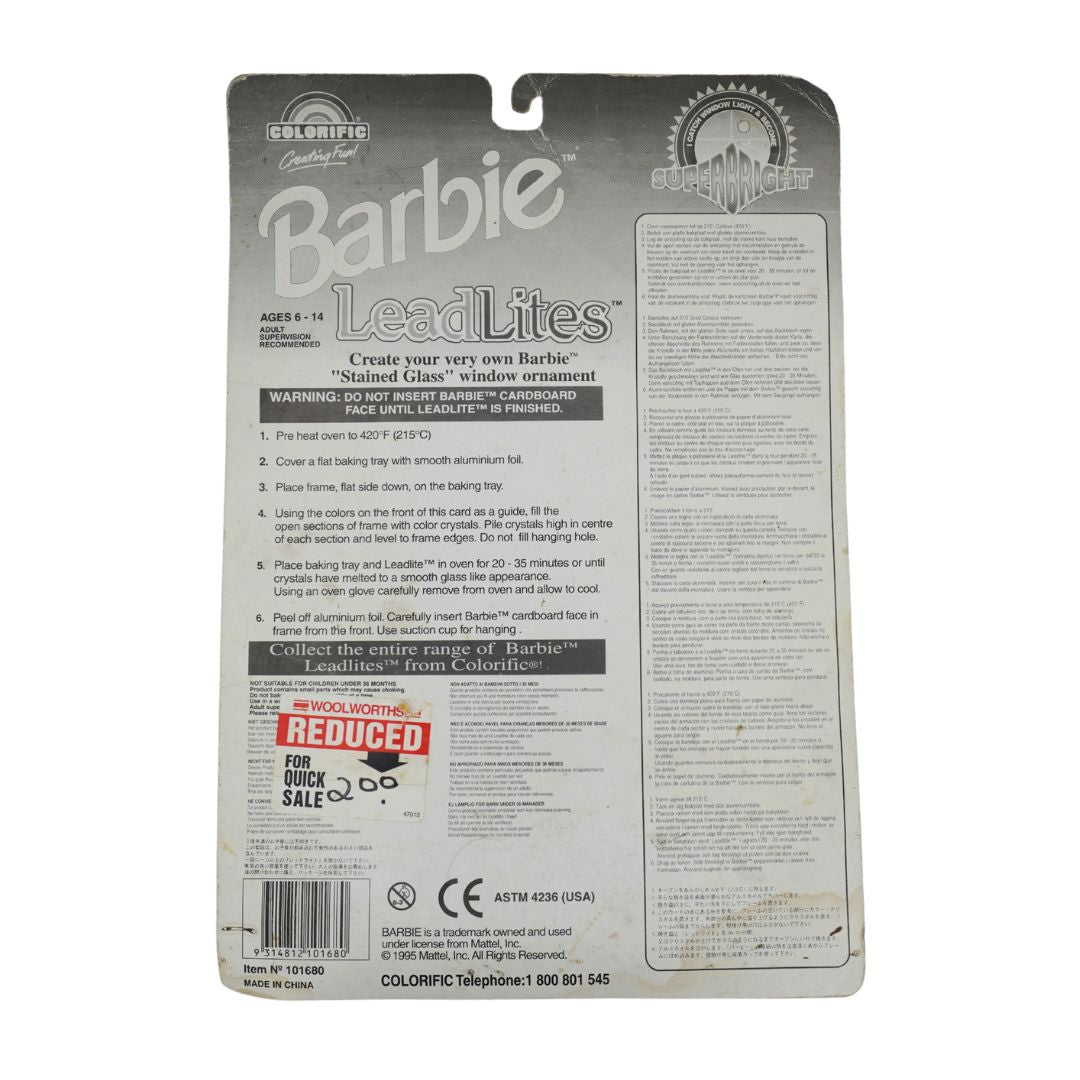 The back of a Barbie LeadLites 'Stained Glass' window ornament packaging card, showing product details, instructions, and a barcode on a white background.