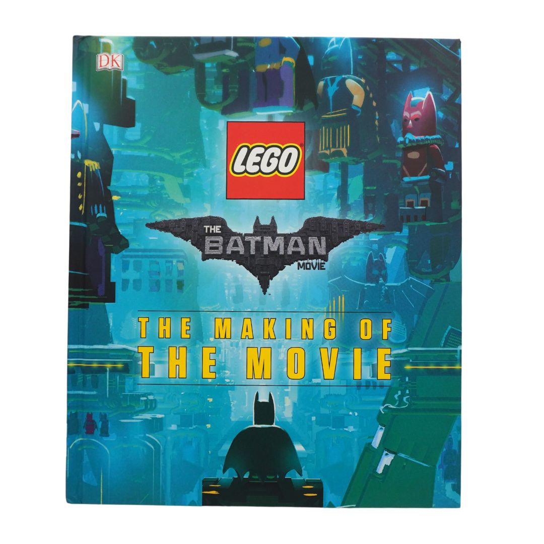 A blue book photographed against a white background showing Batman and Lego branding.