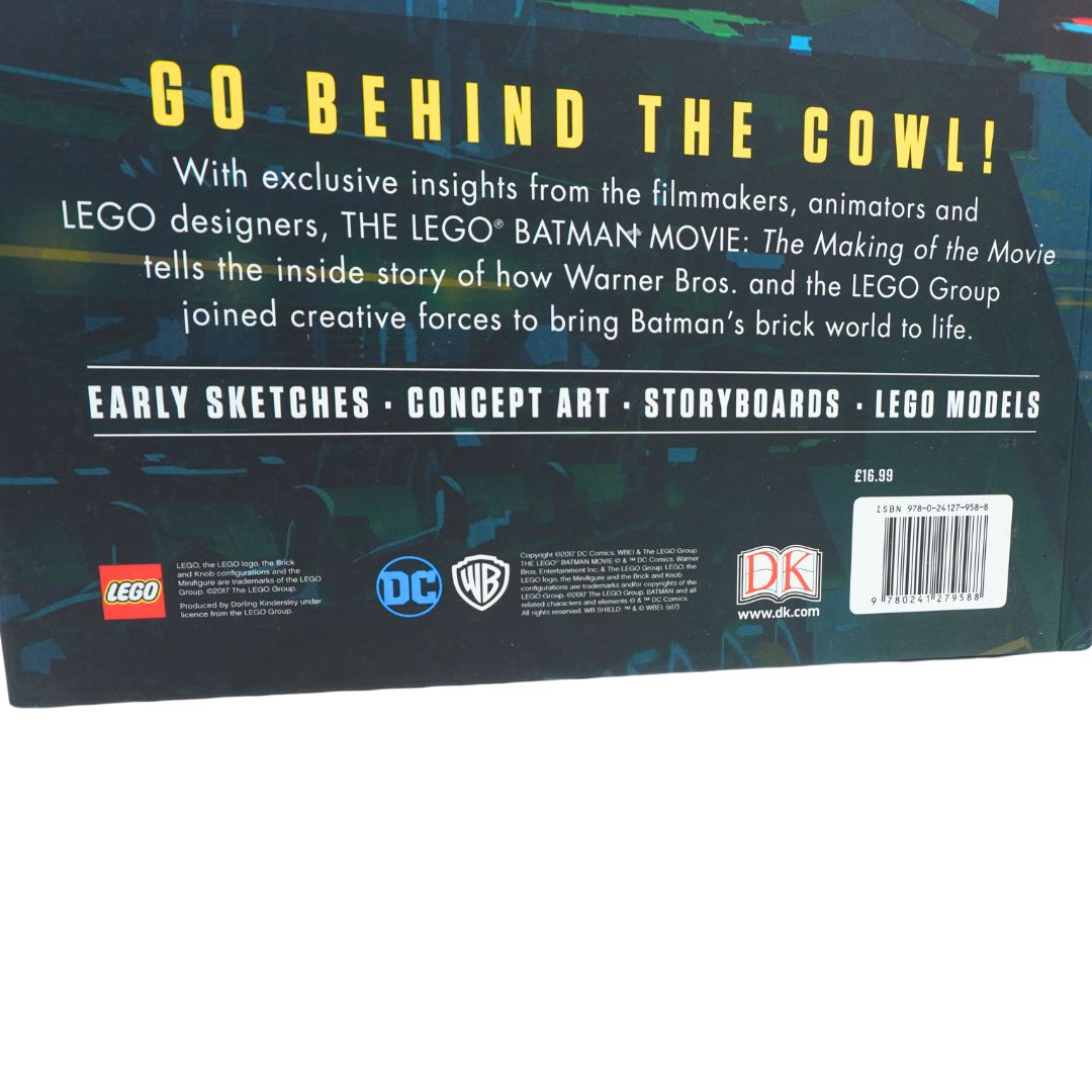 A blue book photographed against a white background showing Batman and Lego branding