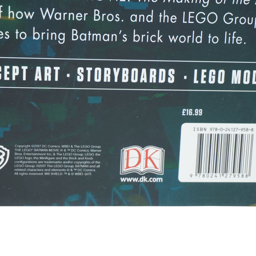 A blue book photographed against a white background showing Batman and Lego branding