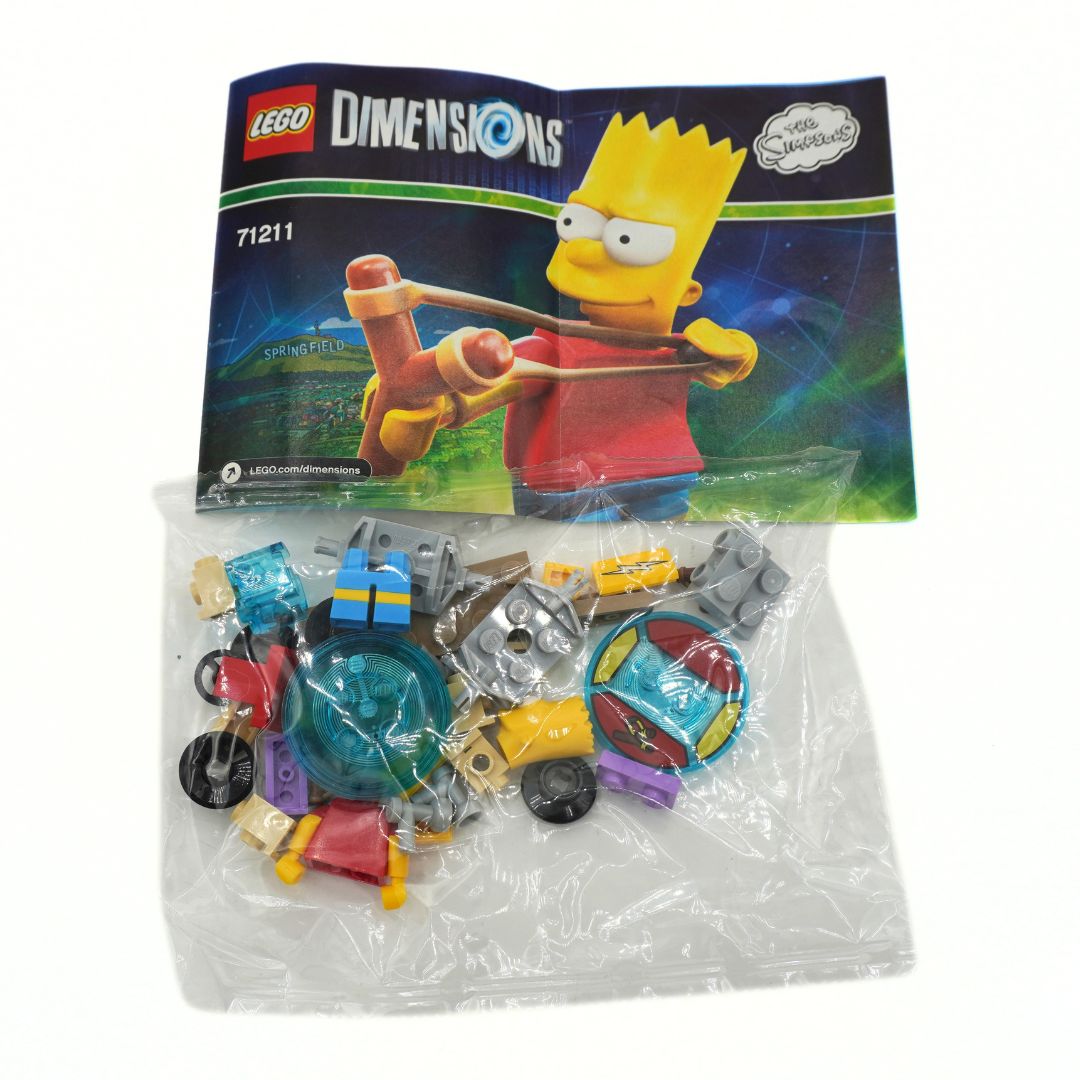 LEGO Dimensions Bart Simpson toy set 71211, showing the instruction booklet and a clear plastic bag containing the assorted building blocks and vehicles on a white background.